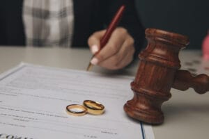 Hands,Of,Wife,,Husband,Signing,Decree,Of,Divorce,,Dissolution,,Canceling