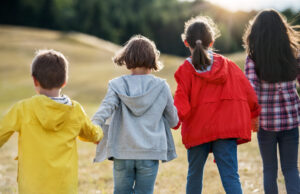 Children holding hands and running.